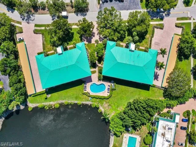 an aerial view of a house with yard swimming pool and outdoor seating