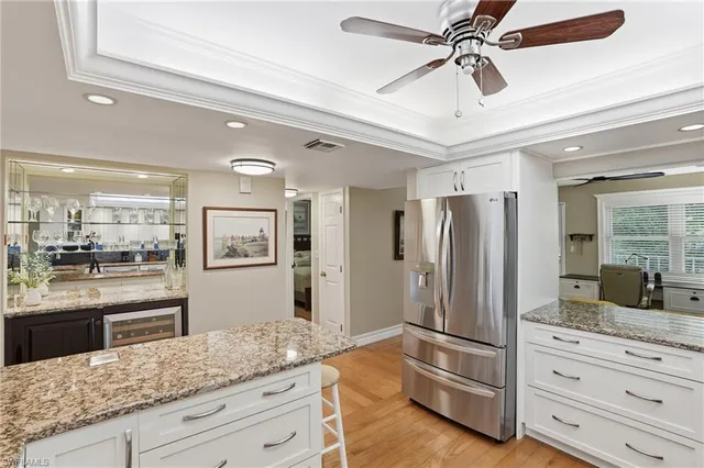 a kitchen with stainless steel appliances granite countertop a refrigerator and cabinets