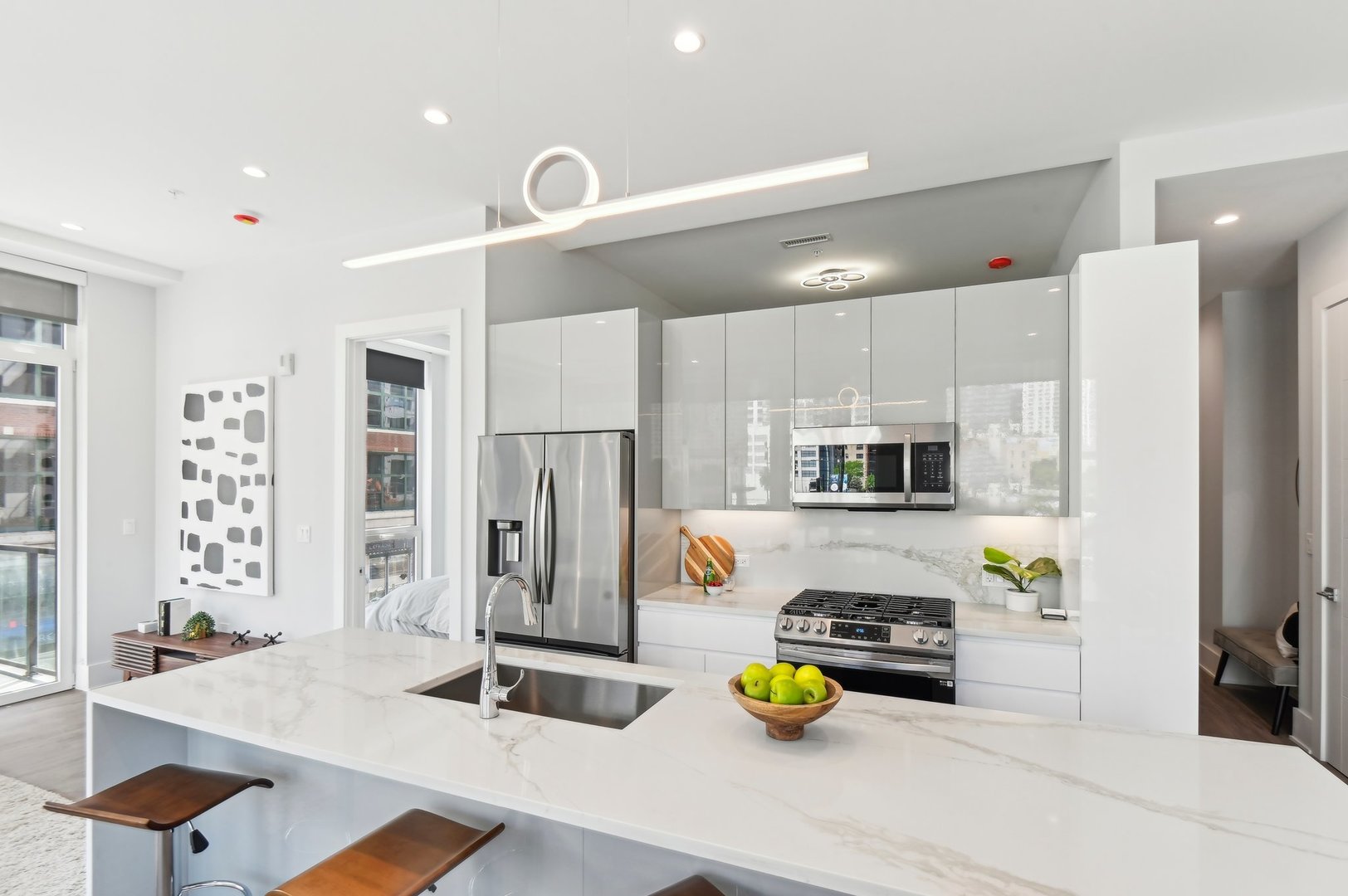 812 West Adams Street, Unit 613 Chicago, IL 60607 - Photo 11 of 32 a kitchen with stainless steel appliances kitchen island granite countertop a refrigerator and a stove