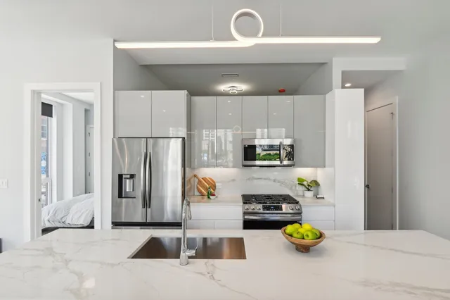 a kitchen with a refrigerator and a stove top oven