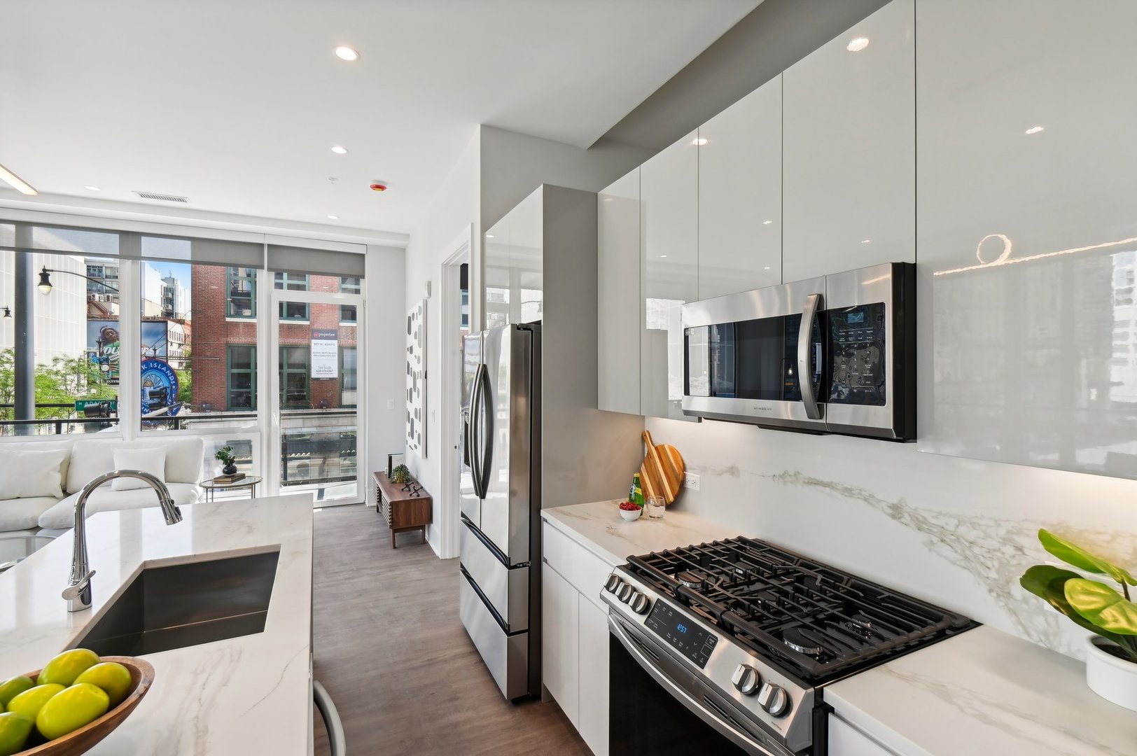 812 West Adams Street, Unit 613 Chicago, IL 60607 - Photo 14 of 32 a kitchen with stainless steel appliances granite countertop a stove a refrigerator a sink dishwasher and white cabinets with wooden floor