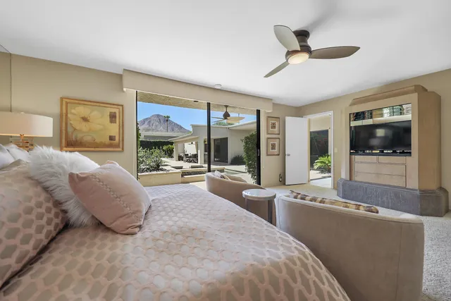 a large bedroom with a large bed and a large window