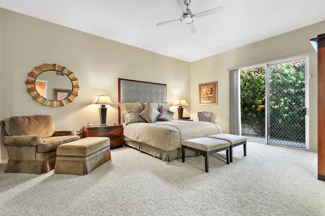 a bedroom with bed and a large window