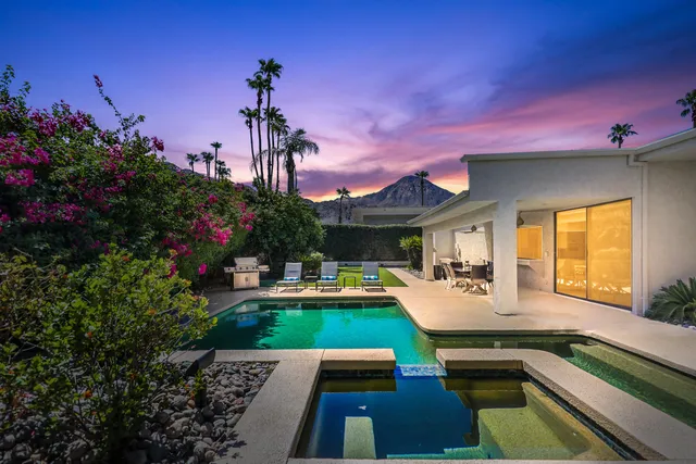 a view of a patio with swimming pool table and chairs