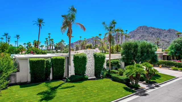 a view of a garden with a building in the background