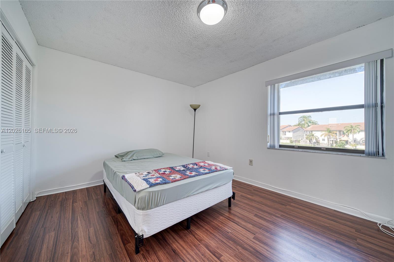 13337 Southwest 64th Lane Miami, FL 33183 - Photo 29 of 36 a bedroom with a bed and a window