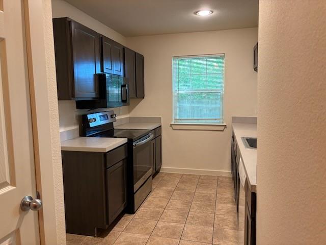 4744 Stokes Street Dallas, TX 75216 - Photo 6 of 20 a kitchen with a sink cabinets and a window