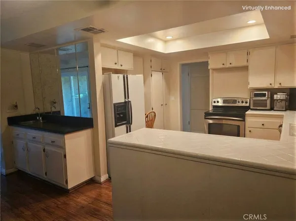 a kitchen with stainless steel appliances a refrigerator and a stove top oven