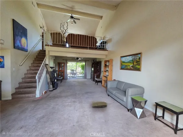 a view of a livingroom with furniture and staircase