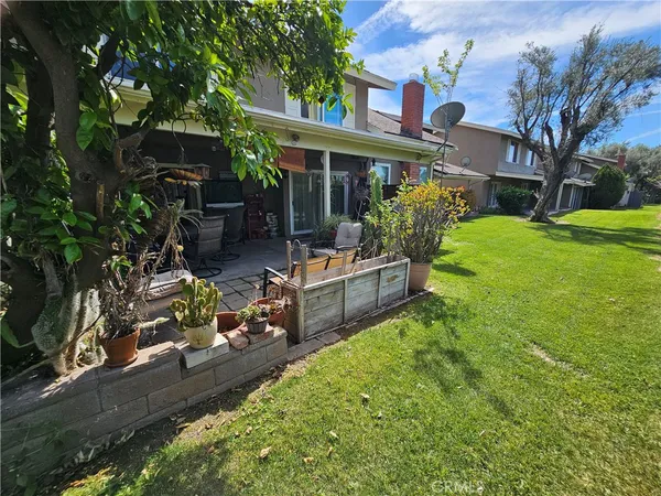 a view of a house with backyard sitting area and garden
