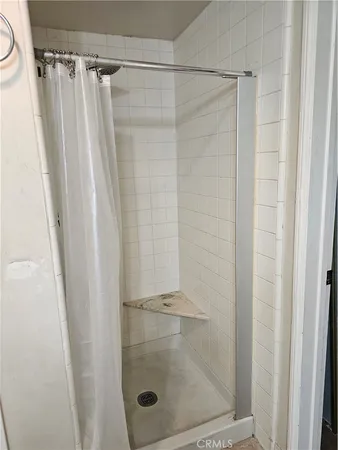 a bathroom with a glass door shower