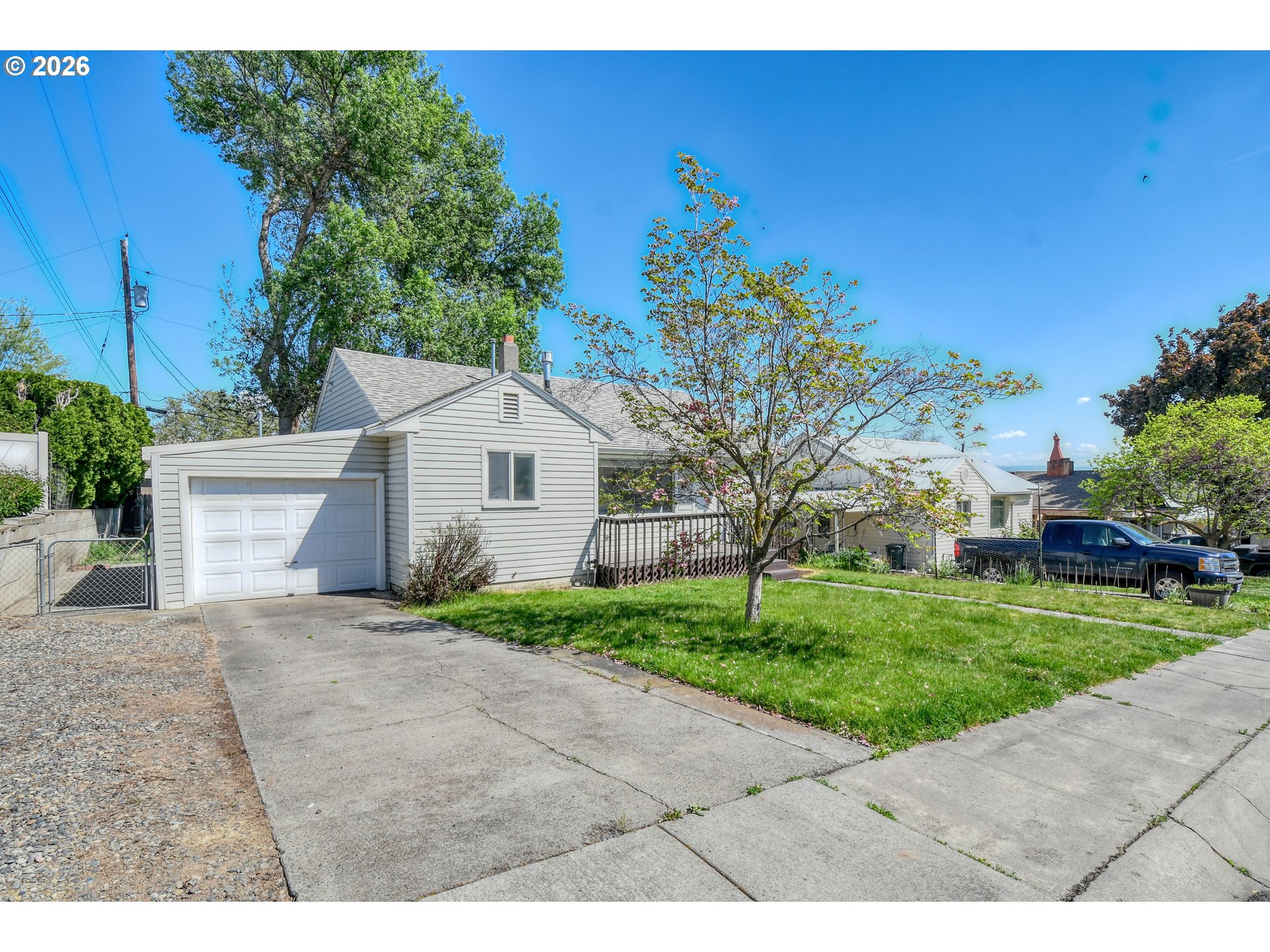 812 Northwest 11th Street Pendleton, OR 97801 - Photo 2 of 28 a view of a white house with a yard and potted plants