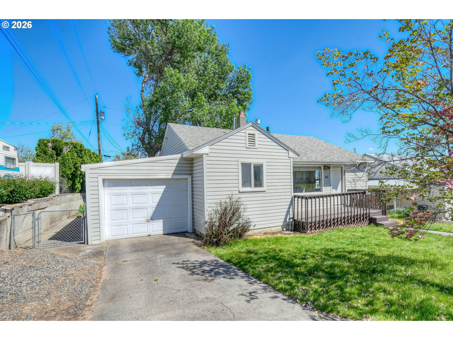 812 Northwest 11th Street Pendleton, OR 97801 - Photo 22 of 28 a white house with a small yard and a large parking space