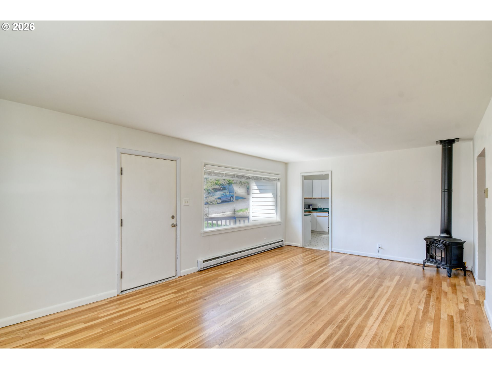 812 Northwest 11th Street Pendleton, OR 97801 - Photo 6 of 28 an empty room with wooden floor and windows