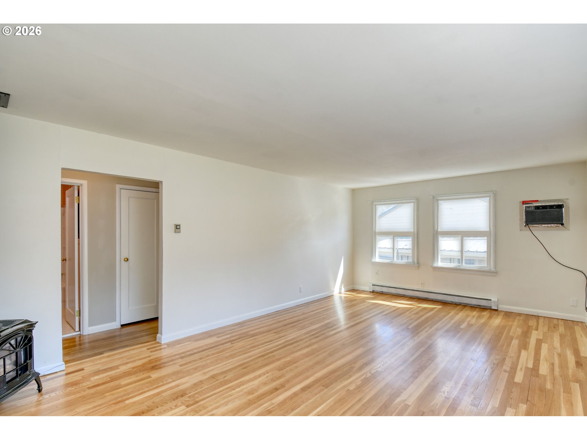 812 Northwest 11th Street Pendleton, OR 97801 - Photo 8 of 28 a view of an empty room with a window and wooden floor