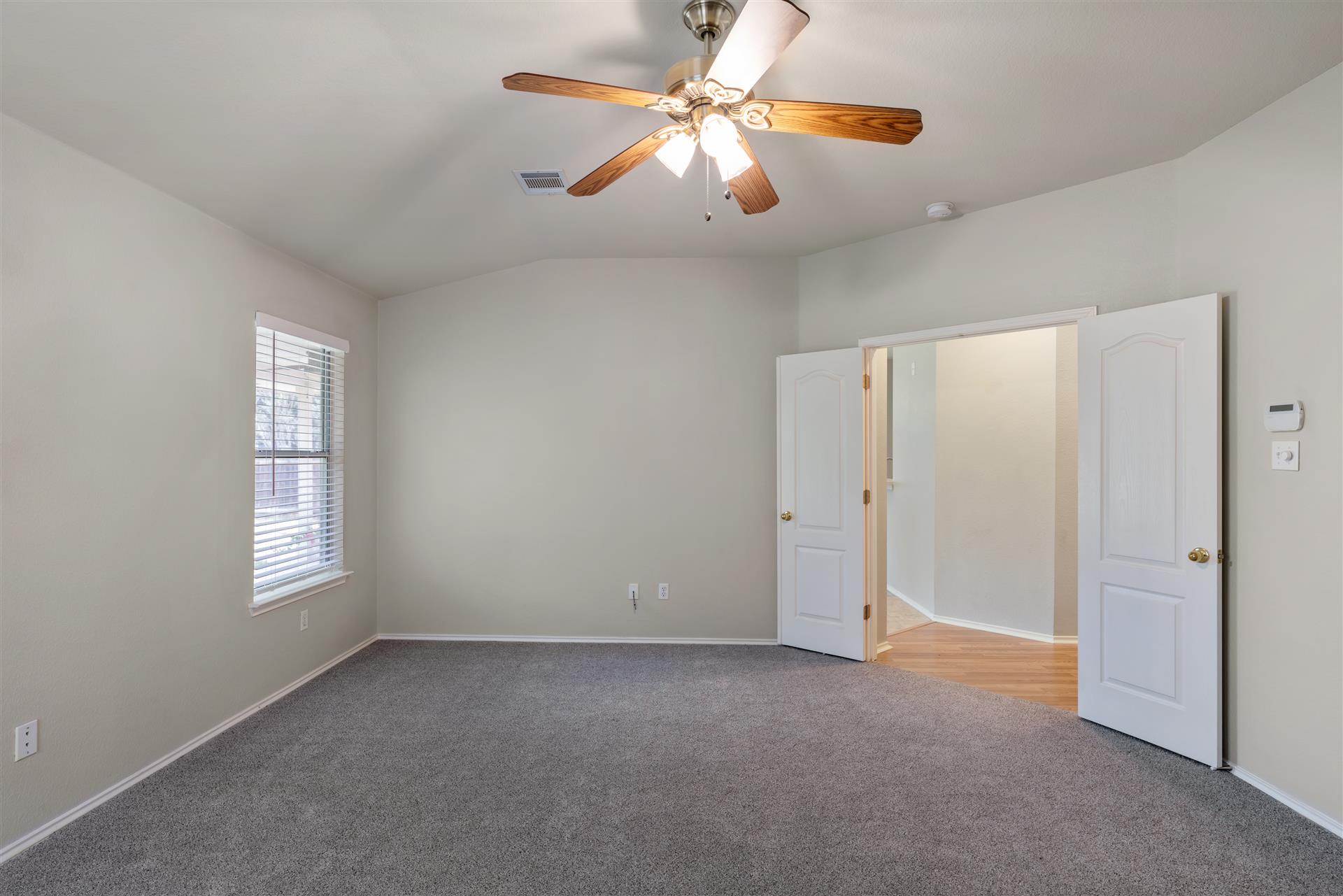 4725 Tello Path Austin, TX 78749 - Photo 16 of 34 A quiet bedroom retreat with plush carpeting and a modern ceiling fan for year-round comfort.