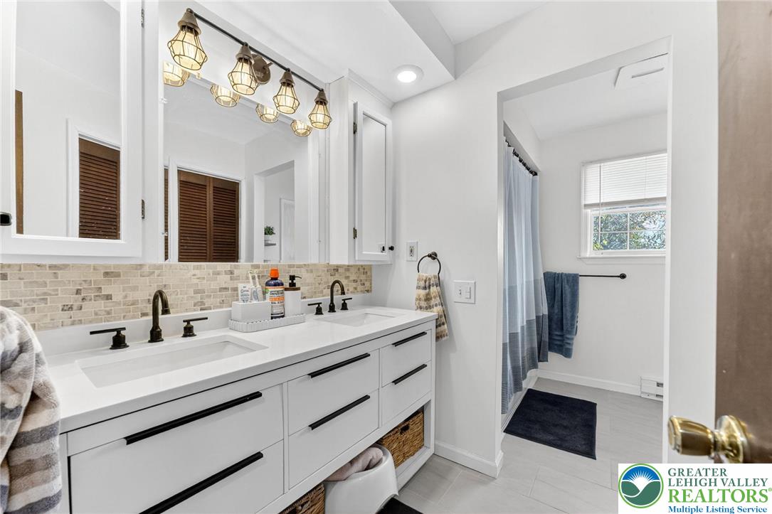 394 Manor Drive Nazareth, PA 18064 - Photo 19 of 44 a bathroom with a sink a mirror and a shower