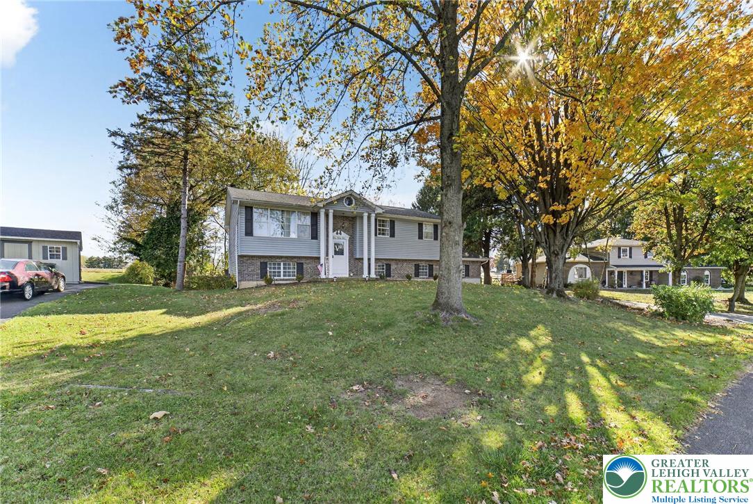394 Manor Drive Nazareth, PA 18064 - Photo 3 of 44 a view of a big house with a big yard and large trees