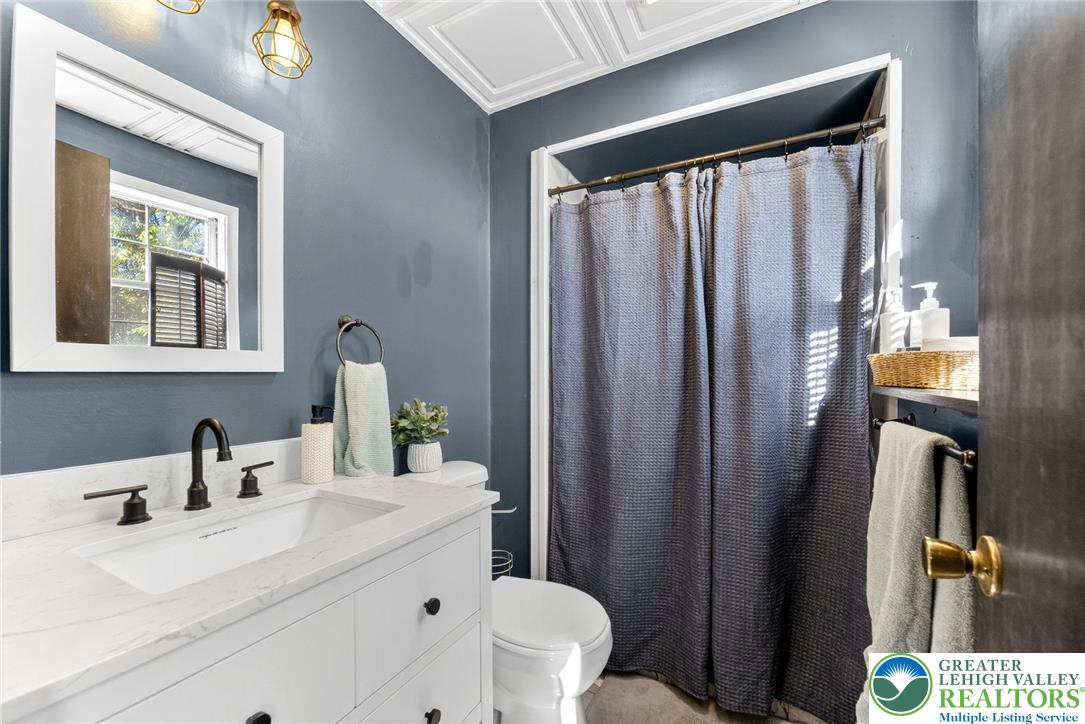 394 Manor Drive Nazareth, PA 18064 - Photo 32 of 44 a bathroom with a sink a toilet and mirror