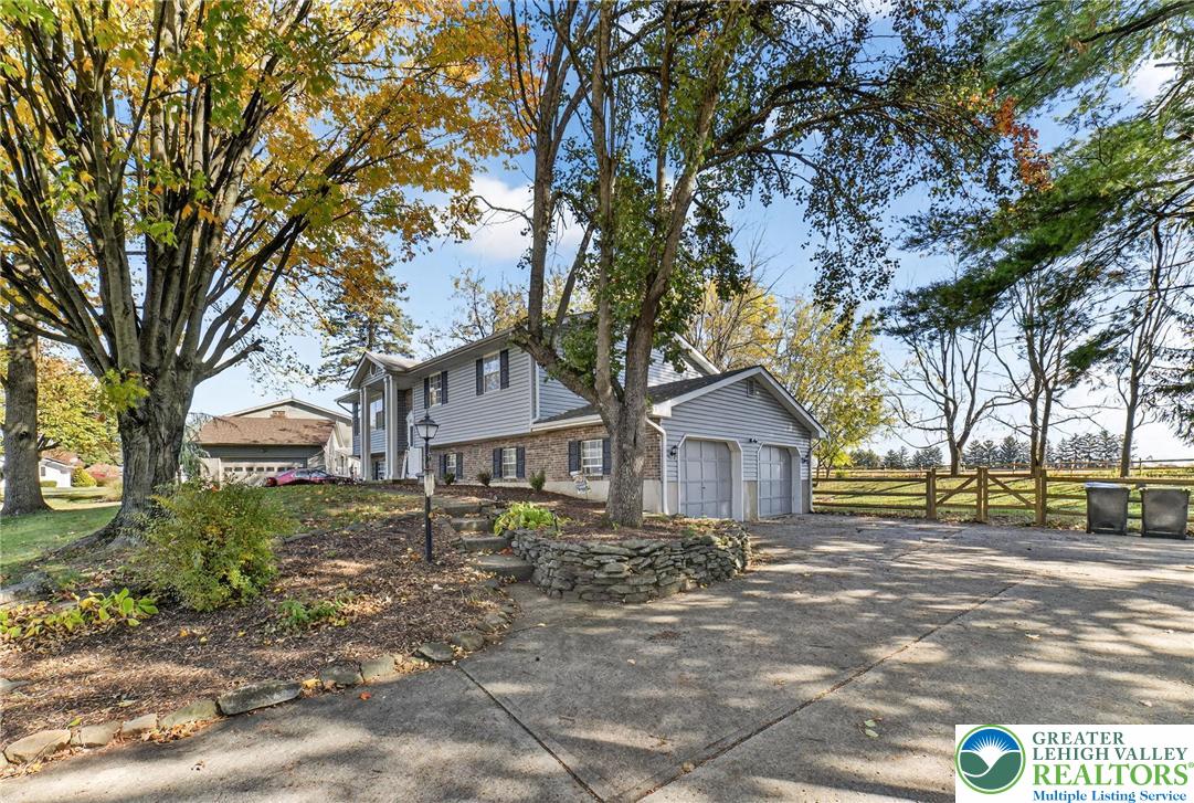 394 Manor Drive Nazareth, PA 18064 - Photo 4 of 44 a front view of a house with a garden