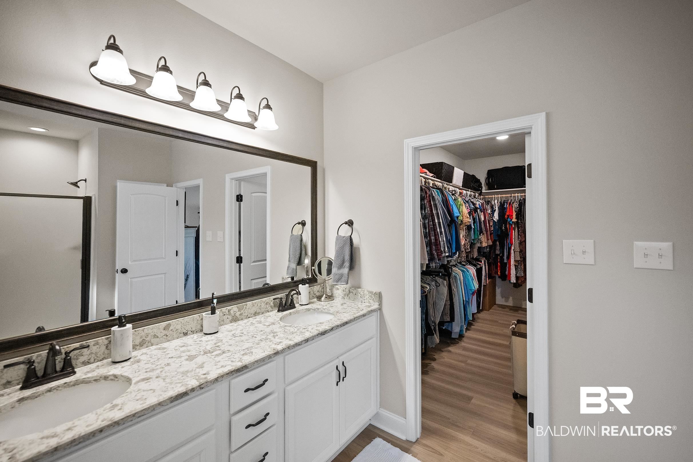 1077 Stella Road Foley, AL 36535 - Photo 21 of 27 Full bathroom featuring double vanity, a walk in closet, an enclosed shower, light wood-style flooring, and recessed lighting