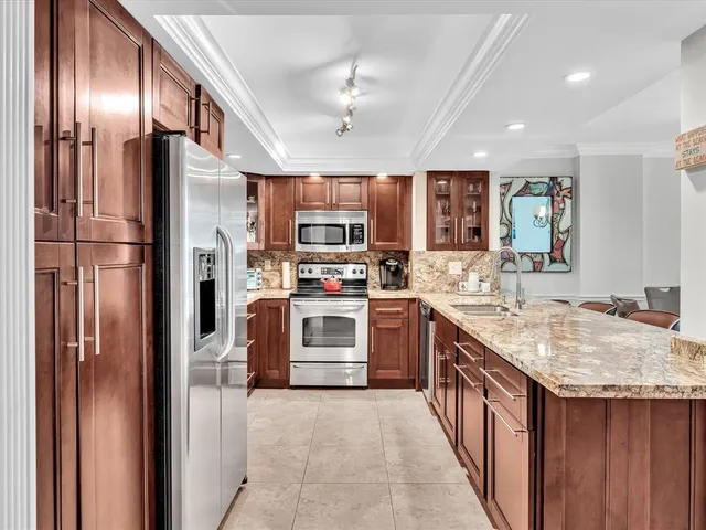 a living room with furniture and floor to ceiling windows