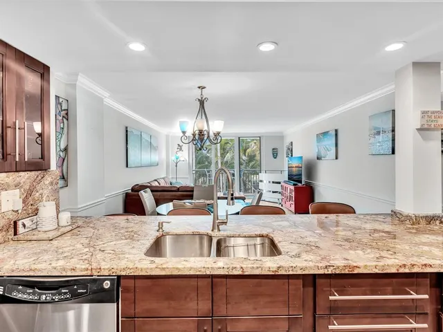 a kitchen with granite countertop a stove and white cabinets