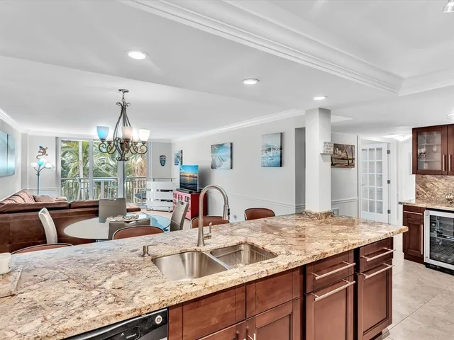 a kitchen with stainless steel appliances granite countertop a refrigerator and a sink