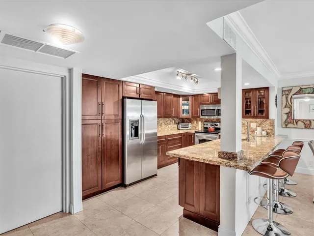 a dining room with wooden floor a chandelier a wooden table and chairs