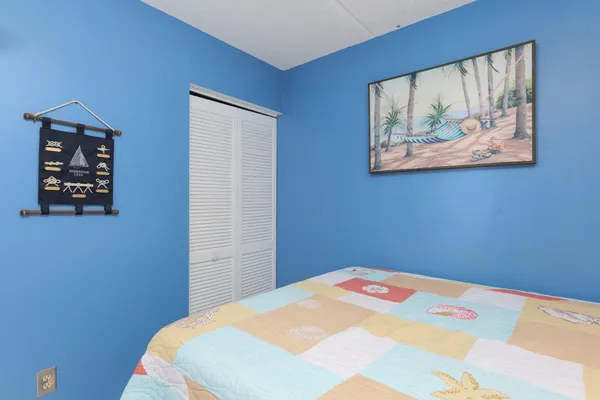 a bedroom with a bed and wall painting