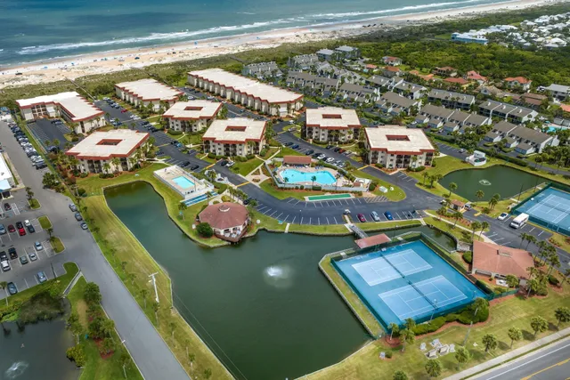 an aerial view of a house with a ocean view