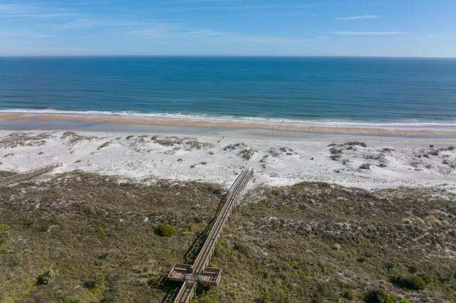 a view of balcony with wooden floor and a bridge
