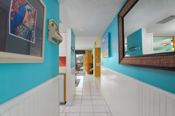 a hallway with a cabinet and a rug