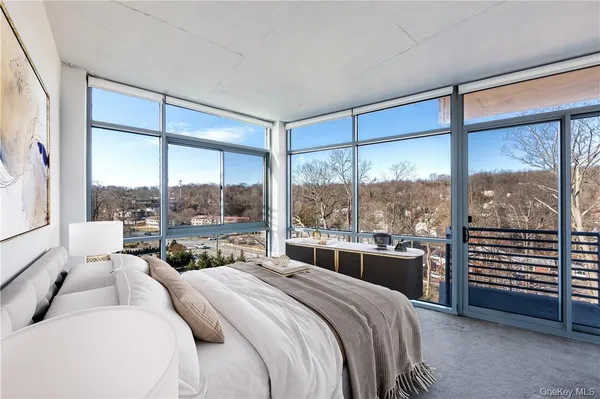 a room with a bed and a large window