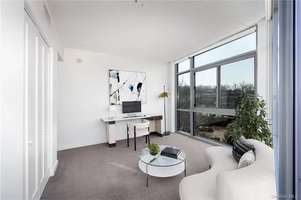 a living room with furniture and a large window