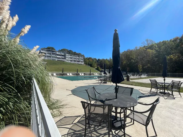 a view of balcony with table and chairs