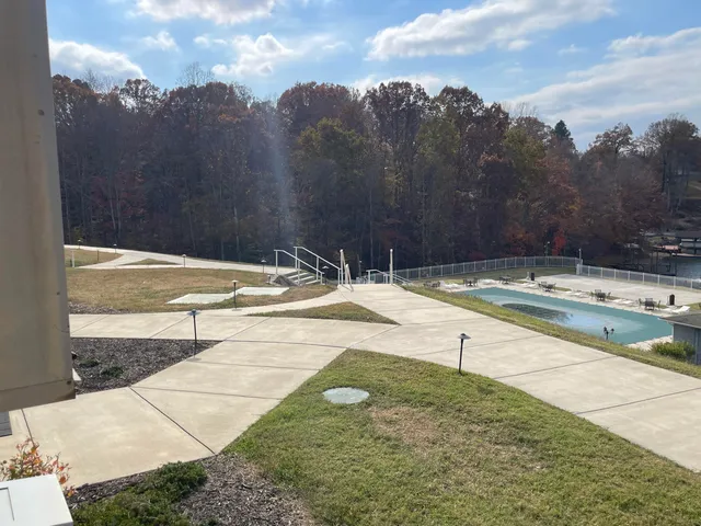 a view of a swimming pool with a yard and mountain view