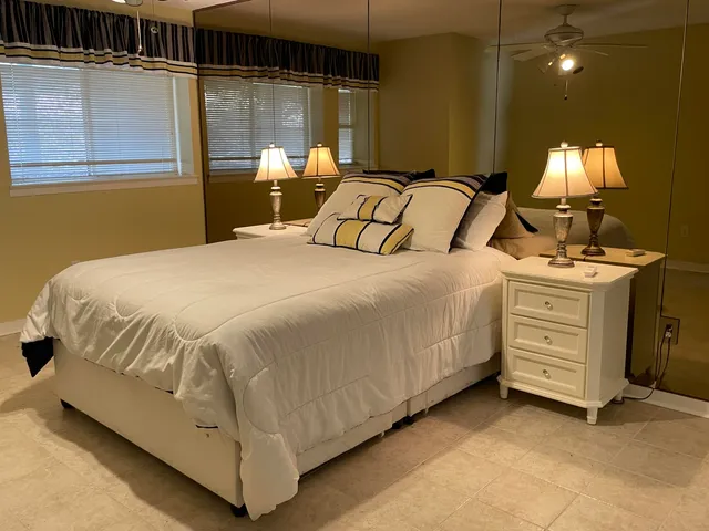 a bedroom with a bed and a lamp