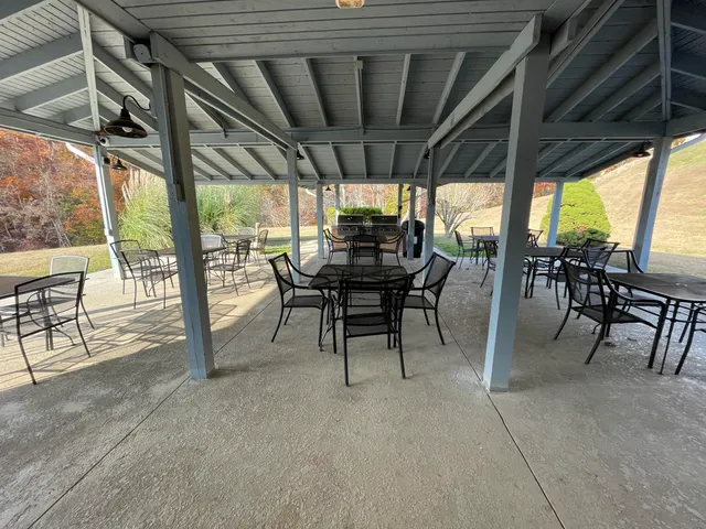 a view of a patio with table and chairs and floor to ceiling window