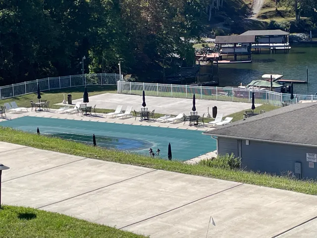 a view of swimming pool with outdoor seating and yard