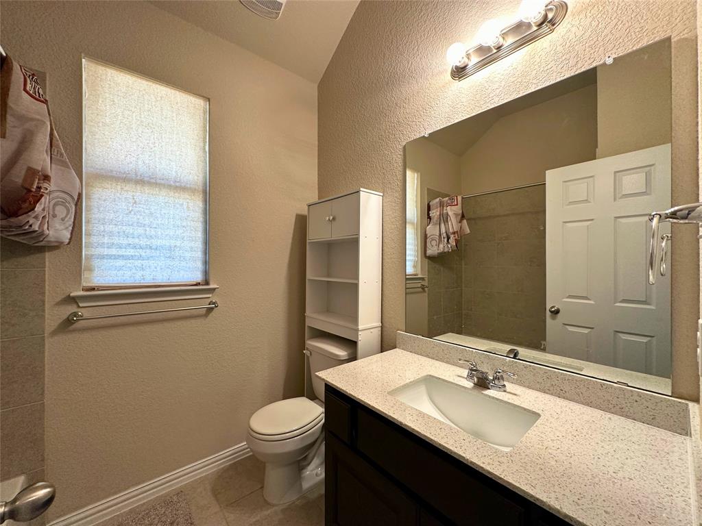 3117 Hidalgo Loop Round Rock, TX 78665 - Photo 24 of 27 a bathroom with a granite countertop toilet sink and mirror