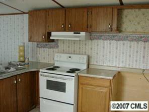 1360 Cason Oldfield Road Morven, NC 28119 - Photo 6 of 7 a kitchen with granite countertop a sink a stove and cabinets