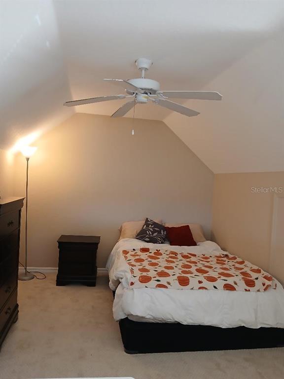 5581 Rosehill Road, Unit 203 Sarasota, FL 34233 - Photo 13 of 17 a bedroom with a bed and a ceiling fan