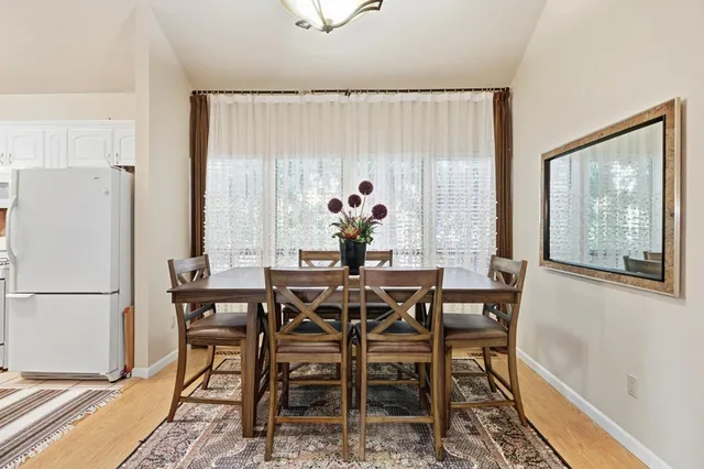a view of a dining room with furniture and a window
