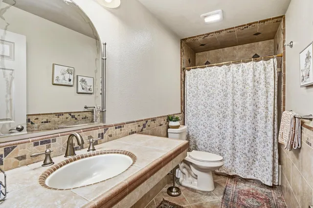 a bathroom with a sink vanity and a mirror