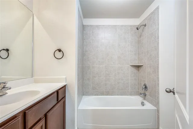 a bath room with a sink and a bath tub