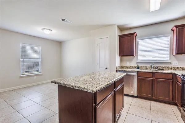 a kitchen with granite countertop sink stove and granite counter top