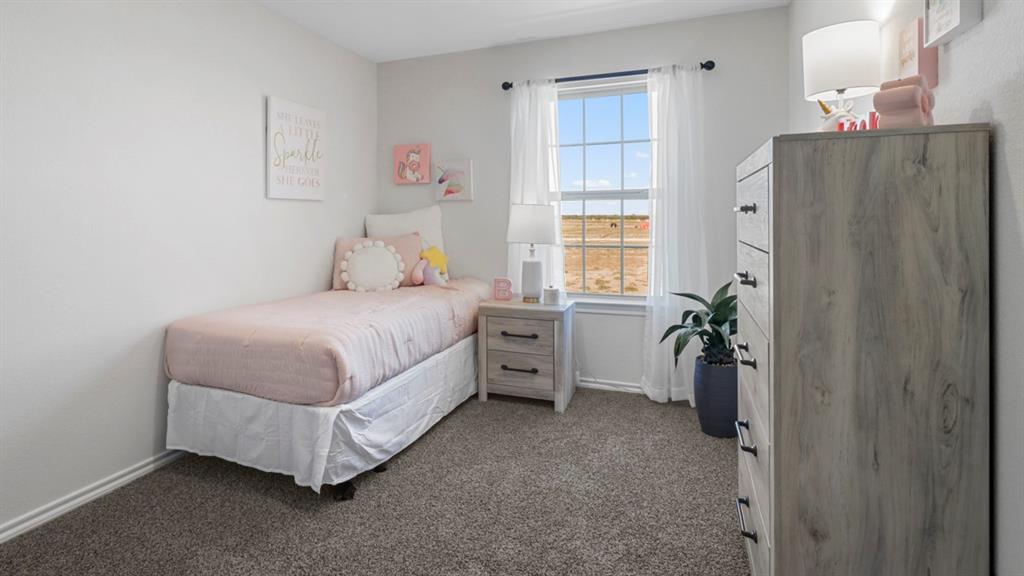 636 Dunham Road Nevada, TX 75173 - Photo 6 of 31 Light-filled room featuring a double-hung window with grid pattern, neutral wall color, and carpeted flooring