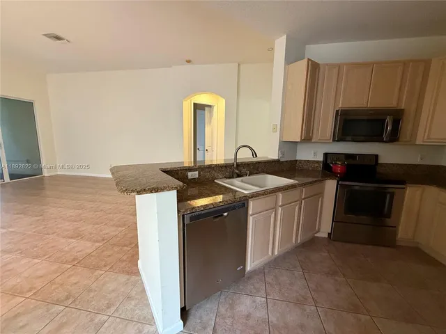 a kitchen with a sink stove and microwave