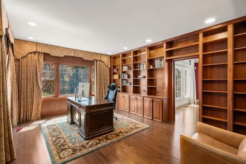 a living room with furniture and a floor to ceiling window